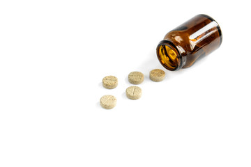 Herbal pills and glass jar isolated on white background.