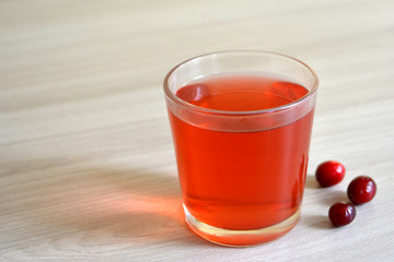Cranberry or berry juice on wooden background. Copy space for text