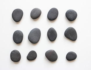 Fototapeta na wymiar black pebbles on white background