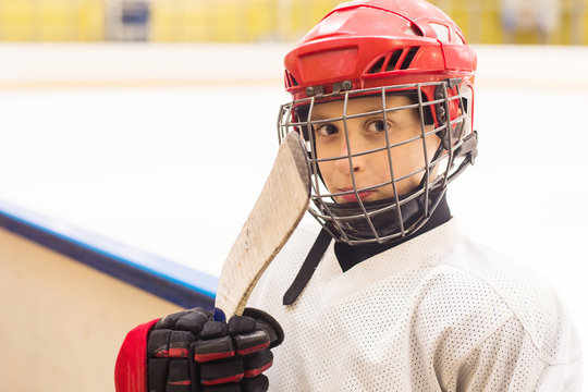 young boy in ice hockey uniform