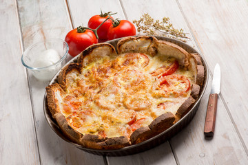 pizza with sliced bread fresh tomatoes and mozzarella