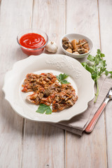 veal escalope with boletus and tomatoes sauce