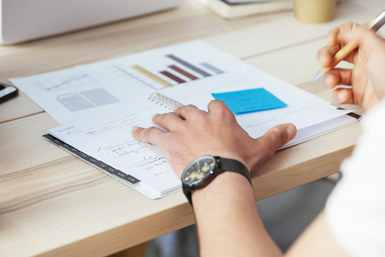 Man working on documents at desk in office