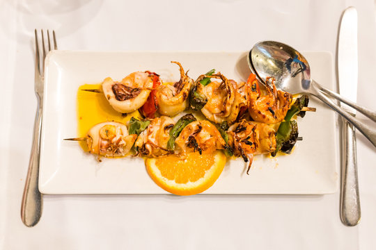 Traditional portuguese dish: Espetada de Lulas e Gambas (skewer with squid and king prawns)