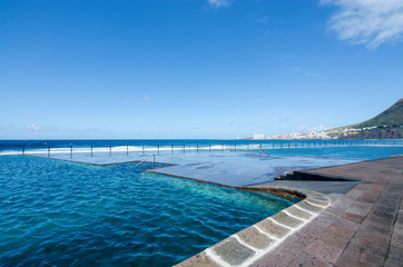 View of natural outdoor swimming pools in the small fishing village Bajamar. Tenerife, Canary Islands, Spain. 