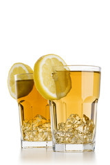 two glasses full of ice tea with lemon slices on white background
