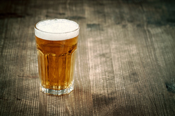 Glass of beer on dark background