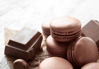 Tasty chocolate macarons on table, closeup