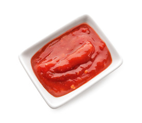 Bowl with delicious tomato sauce on white background