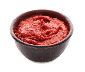 Bowl with delicious tomato sauce on white background