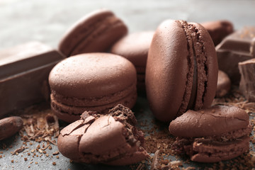 Delicious chocolate macarons on table