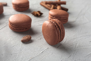 Delicious chocolate macarons on grey background