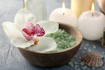 Obraz na płótnie Canvas Spa composition with sea salt and orchid flower in wooden bowl, closeup