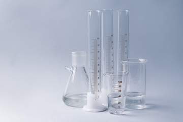 Different laboratory glassware on grey background