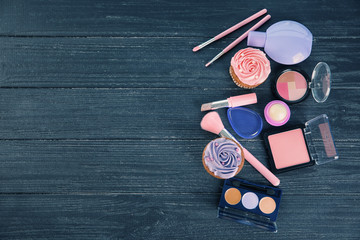 Composition with decorative cosmetics on wooden background