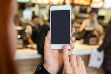 Woman using mobile phone on blurred background
