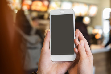 Woman using mobile phone on blurred background