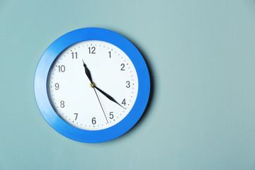 Modern clock on color wall. Time management concept