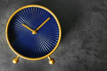 Alarm clock on grey textured background. Time management concept