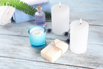 Fototapeta na wymiar Beautiful spa composition with natural soap and burning candles on wooden background