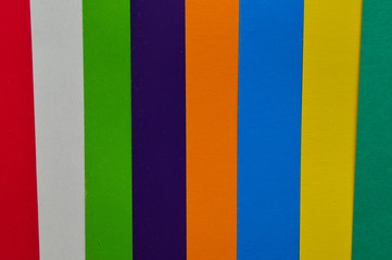 Colored paper as an abstract colorful background. Colored paper in stripes