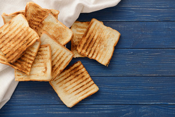 Tasty toasted bread on wooden background, top view