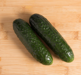 Cucumbers on a wooden stand.
