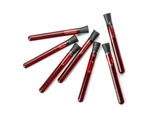 Test tubes with blood samples on white background