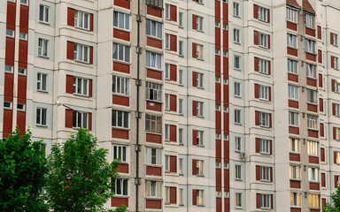 Windows in a panel house with a balcony.