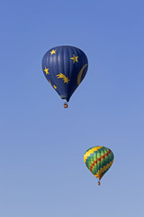 Hot air balloons float over California vineyards