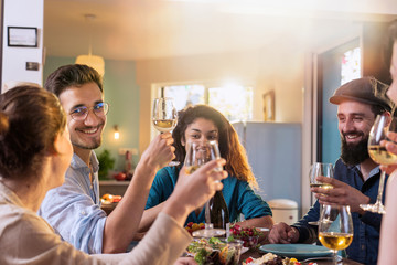 Multi-ethnic group of friends having fun while sharing a meal 