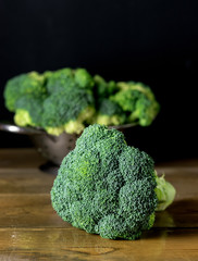 Fresh Ripe Broccoli in Bowl on Rustic Wooden Background Veertical