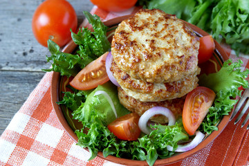 Fried cutlets and vegetable salad on a plate..Shallow DOF