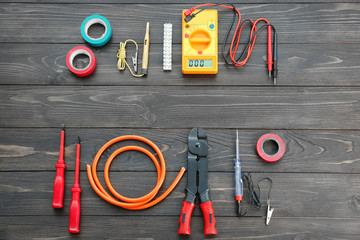 Flat lay composition with electrical tools on wooden background