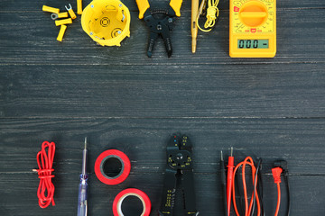Flat lay composition with electrical tools on wooden background