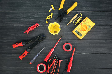 Flat lay composition with electrical tools on wooden background