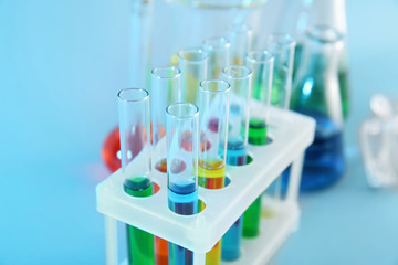 Test tubes with colorful liquids in holder, closeup