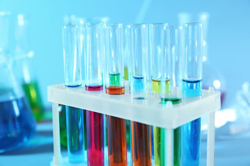 Test tubes with colorful liquids in holder, closeup
