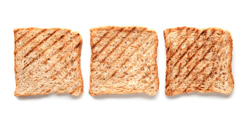 Tasty toasted bread on white background, top view