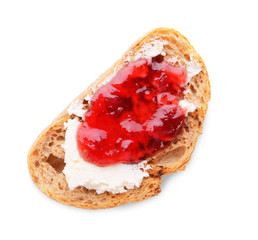 Toasted bread with cream cheese and jam on white background, top view