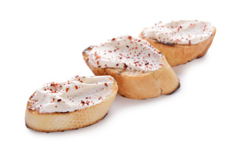 Toasted bread with cream cheese on white background