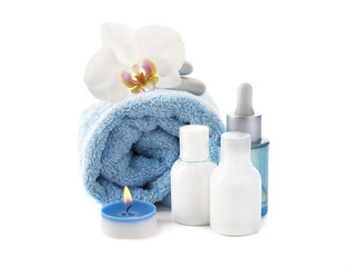 Obraz na płótnie Canvas Beautiful spa composition with cosmetics, towel and burning candle on white background