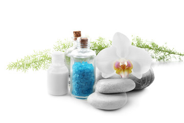 Beautiful spa composition with bottle of sea salt and stones on white background