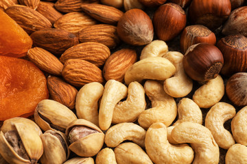 Different nuts, dried fruits and berries as background