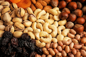 Different nuts, dried fruits and berries as background