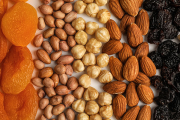 Different nuts, dried fruits and berries as background