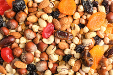 Different nuts, dried fruits and berries as background