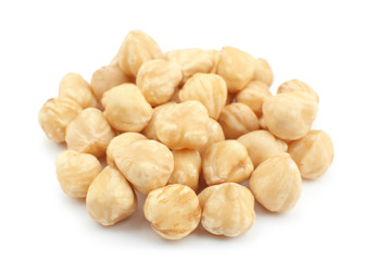 Peeled hazelnuts on white background