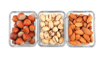Glass bowls with different nuts on white background, top view