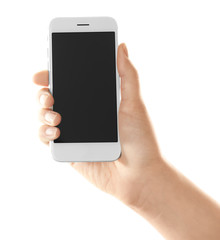 Young woman holding smartphone on white background